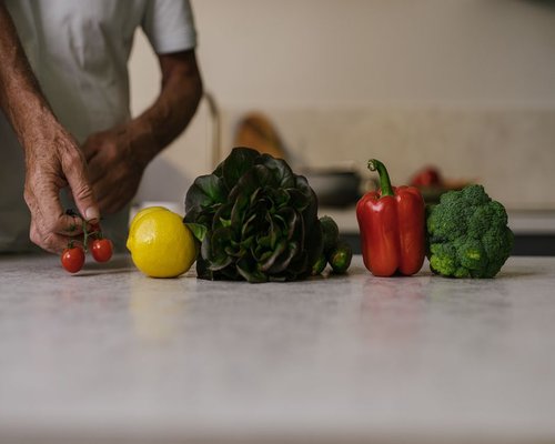 Fresh vegetables and fruits arranged on a kitchen counter